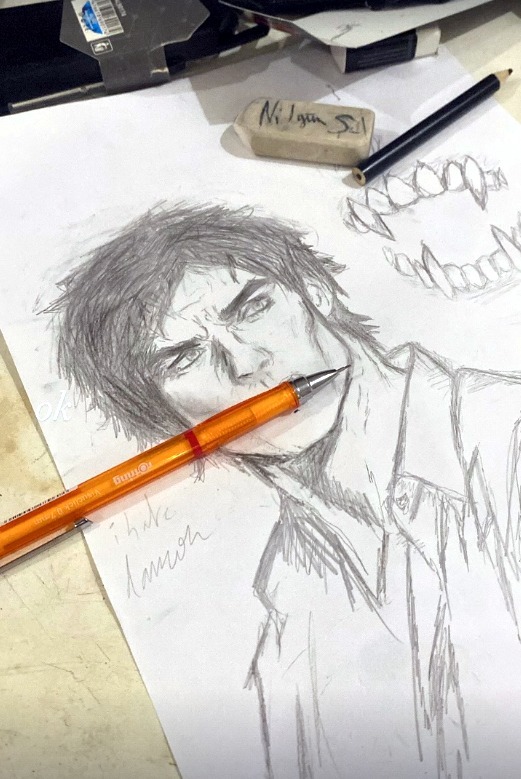 Her desk: a pencil drawing in progress, an eraser with her name on it